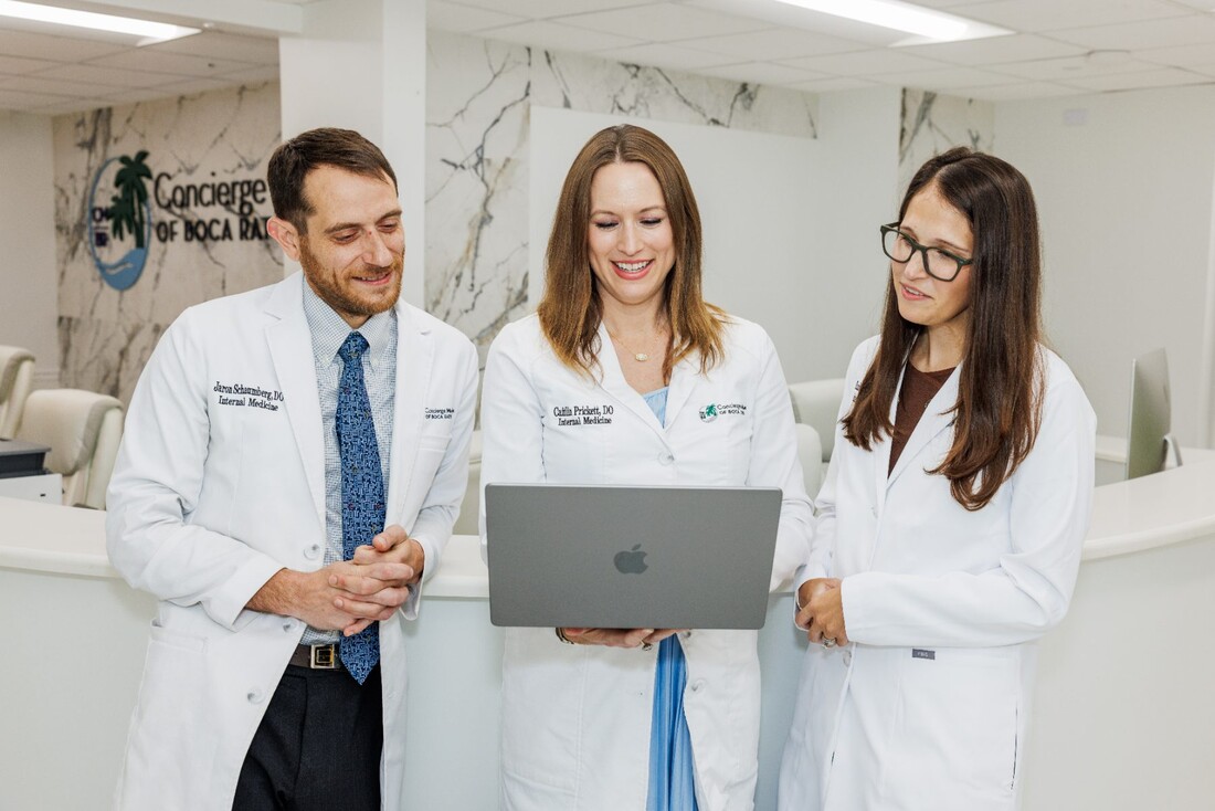 Three physicians of Concierge Medicine of Boca Raton reviewing patient information together